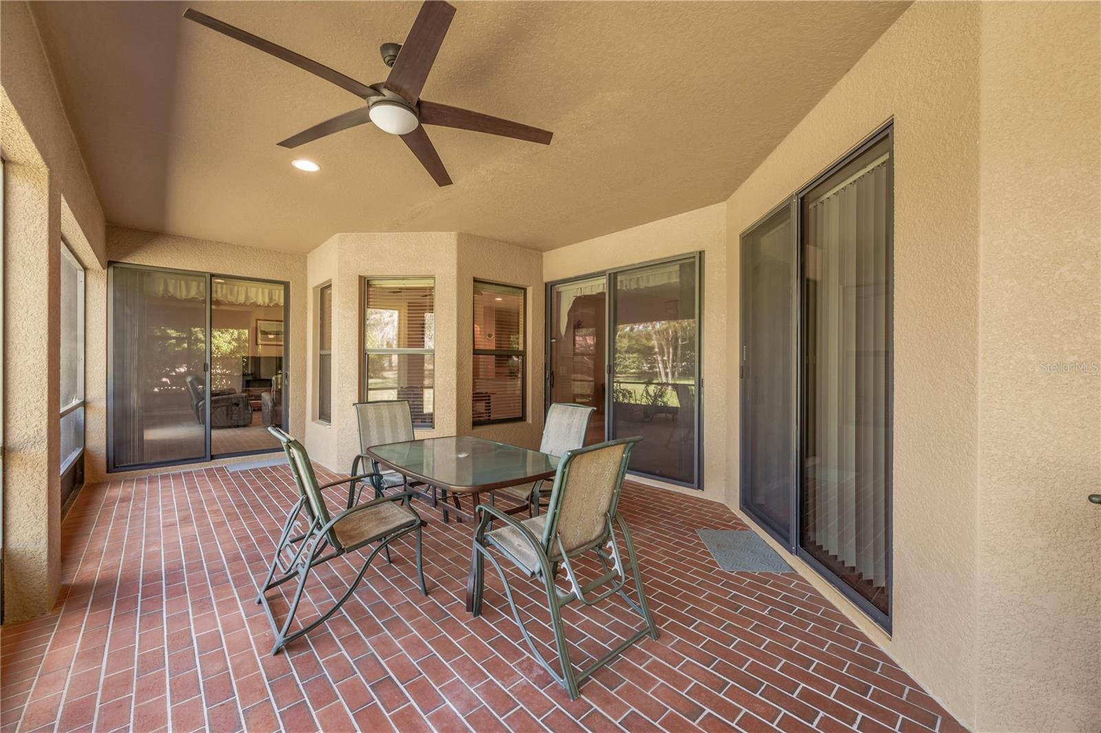 The spacious 32' x 15' covered and screened lanai can be accessed through sliding doors from the family room, living room, and primary suite, creating seamless indoor-outdoor living.