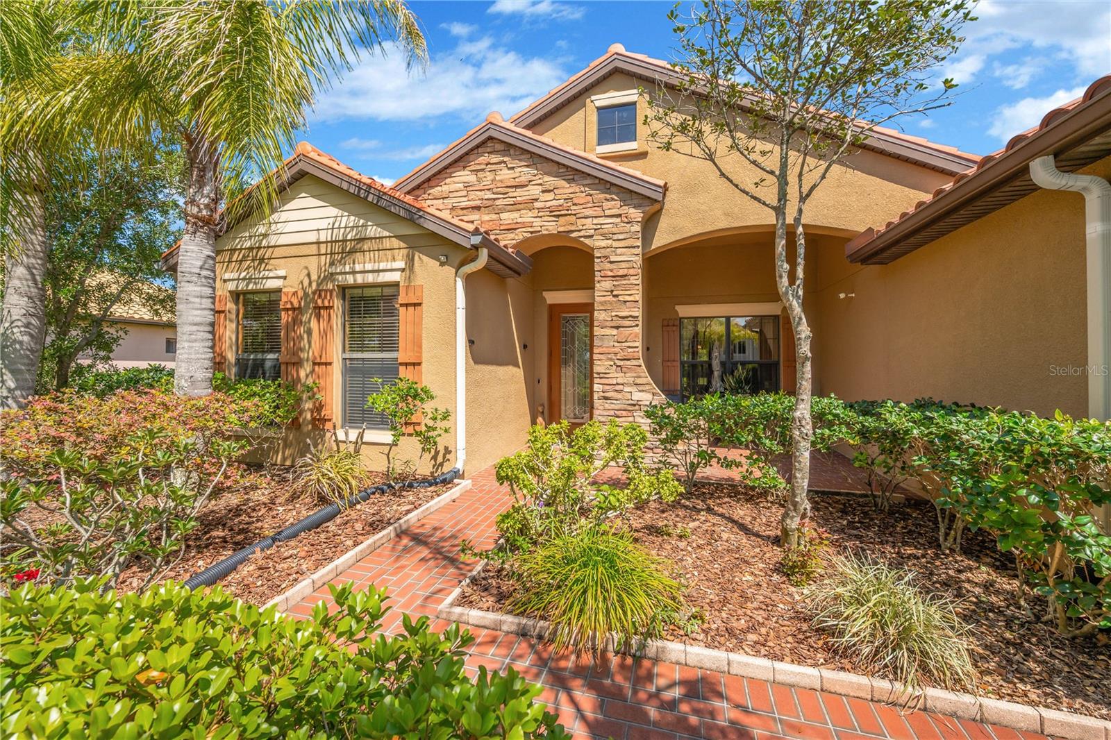 Impeccably maintained and rich in curb appeal, this residence welcomes you with a professionally landscaped yard, classic Spanish tile roof and stone accents.