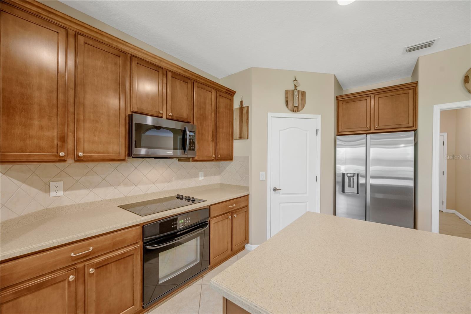 Kitchen features include a separate cooktop, built-in oven, and built-in microwave for a sleek and functional kitchen design.