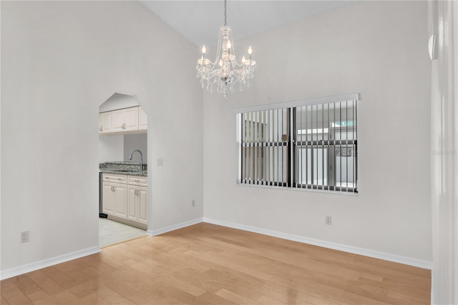 The dining room is highlighted by a stunning chandelier that adds elegance and charm.