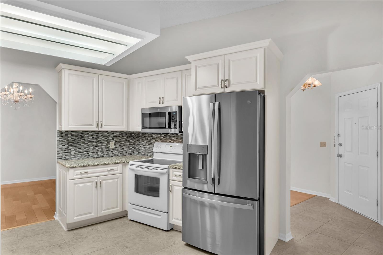 The open floor plan flows effortlessly into the updated kitchen.