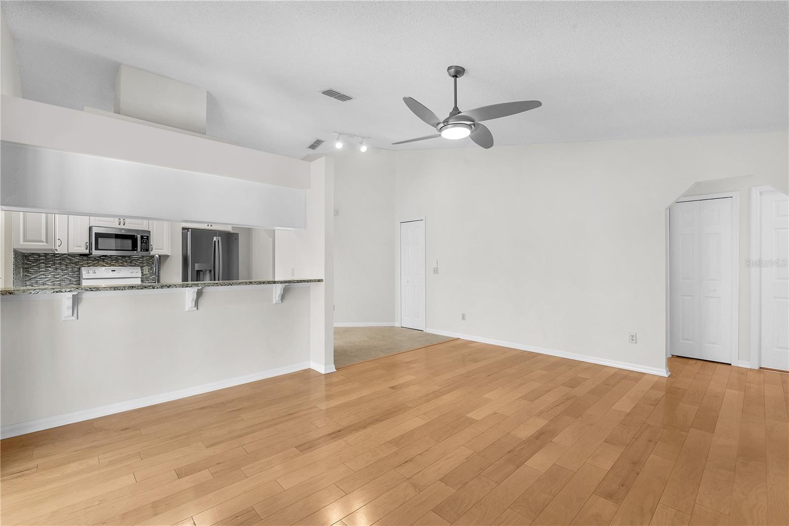 Just off the kitchen, the inviting family room boasts a vaulted ceiling.