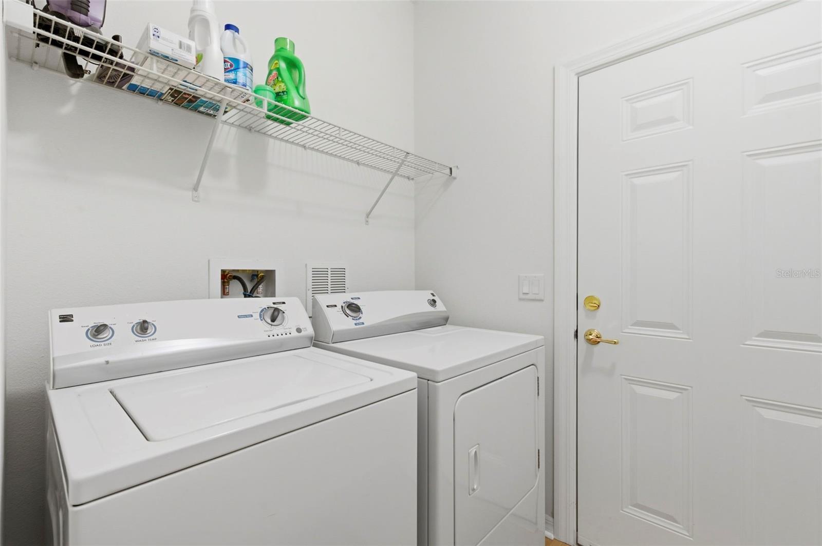 Indoor laundry room space and garage door.
