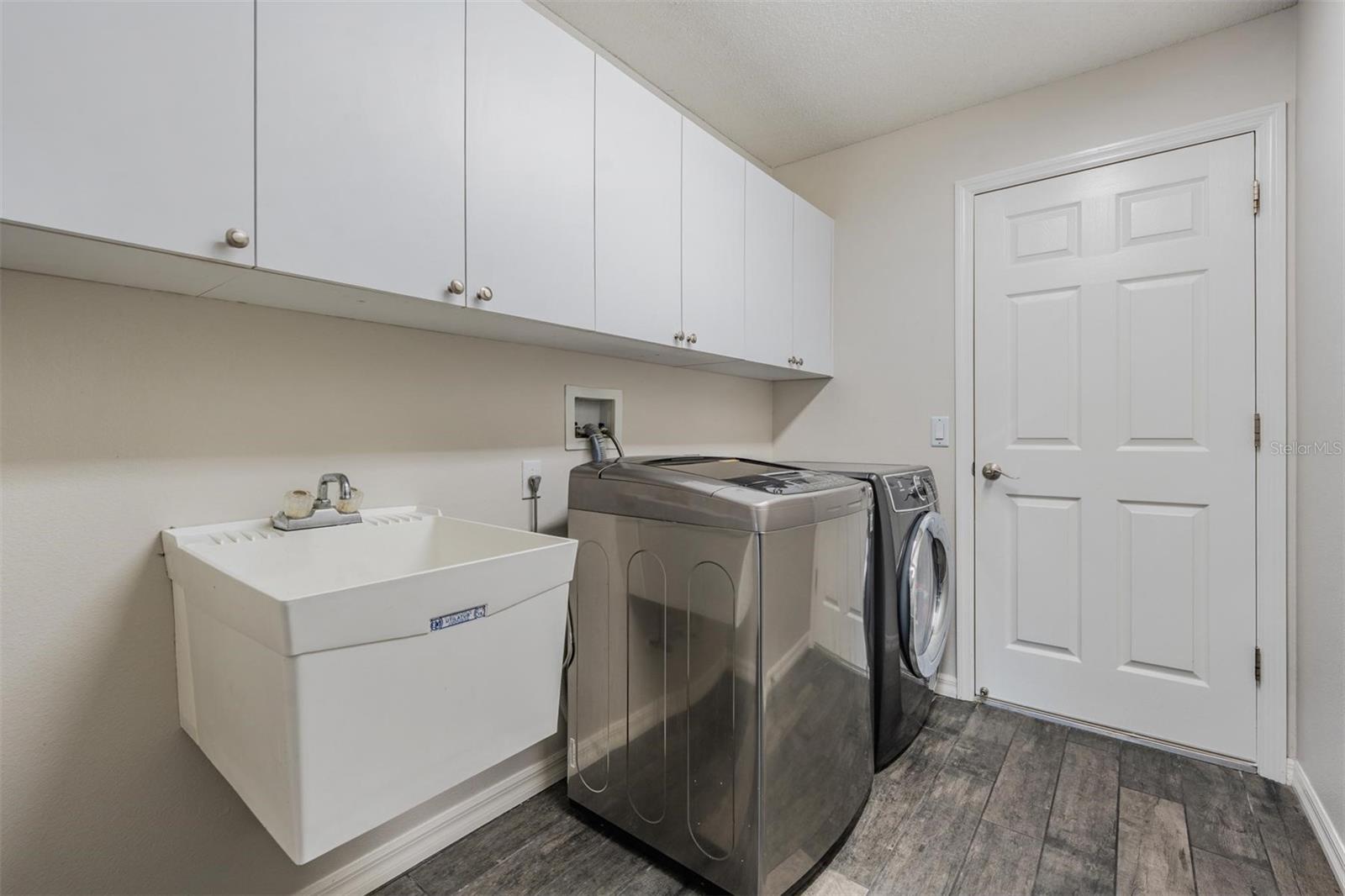 Walk in laundry room with sink and storage