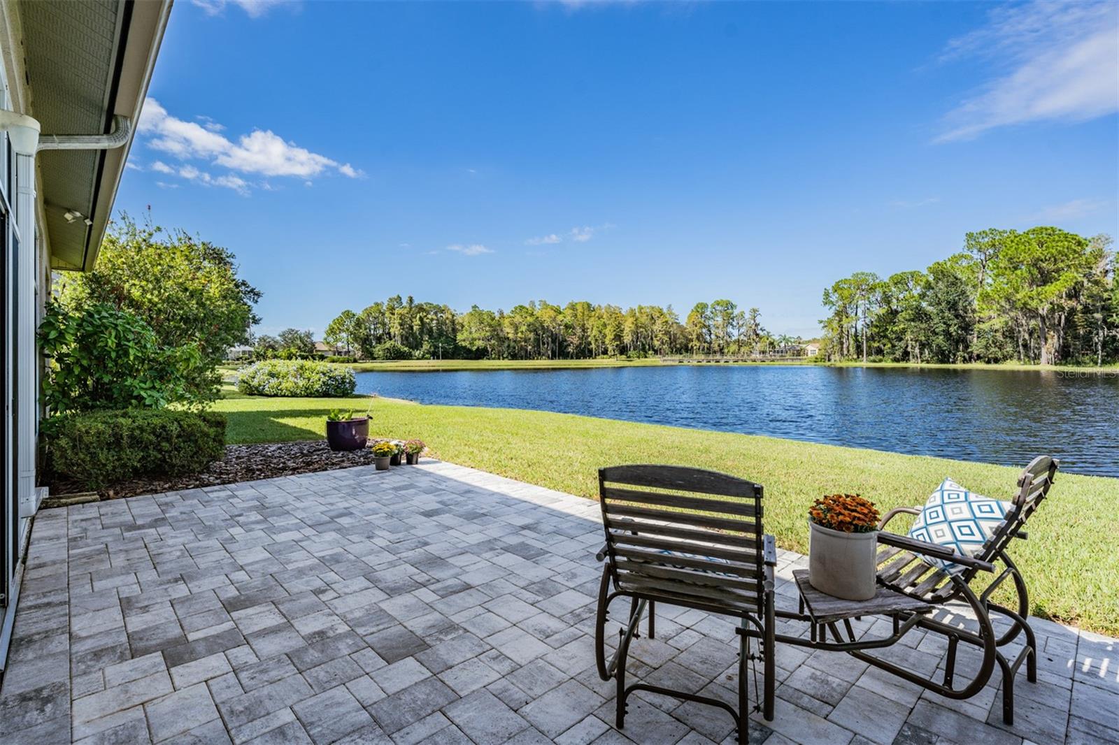 Sunny pond view from pavered patio