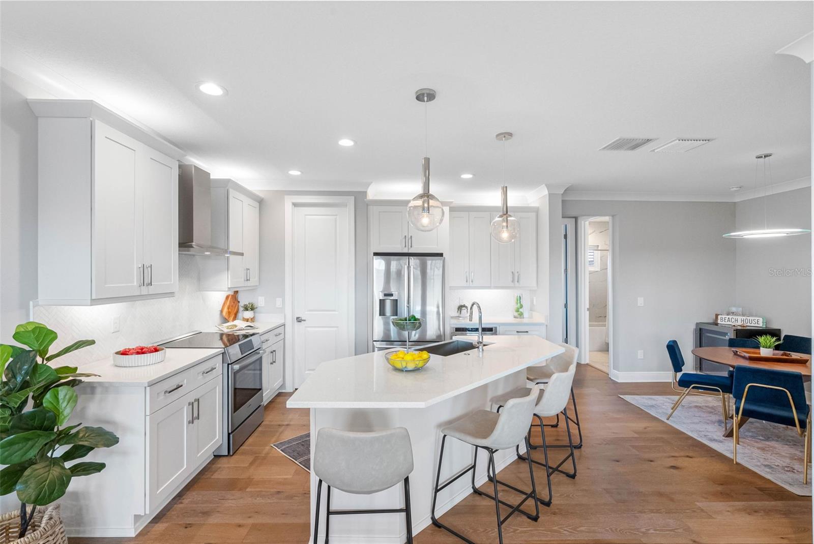 Kitchen is open to the dining area with recess lights and under and over cabinet accent lighting