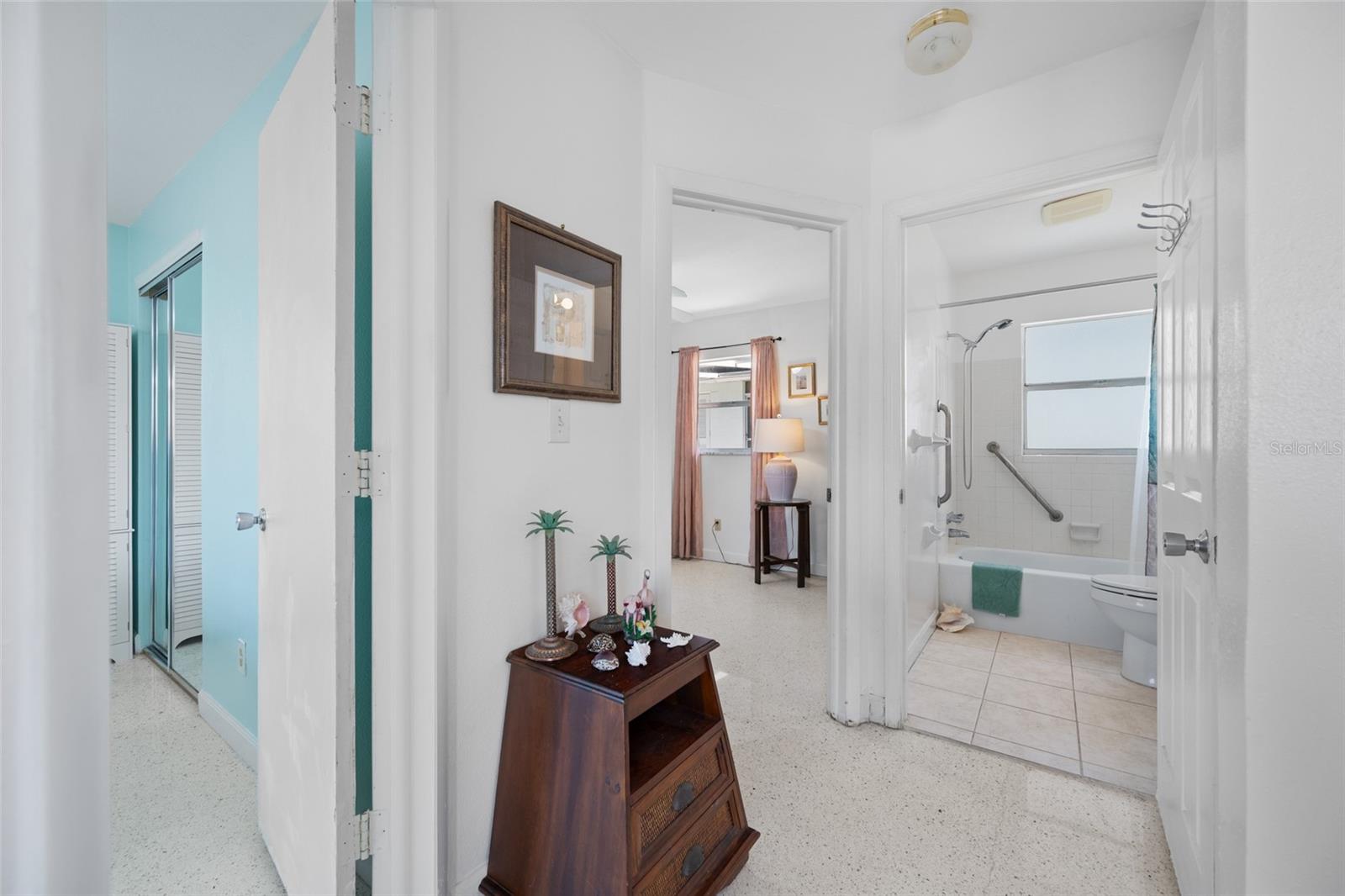 Hallway looking into multiple rooms and bathroom