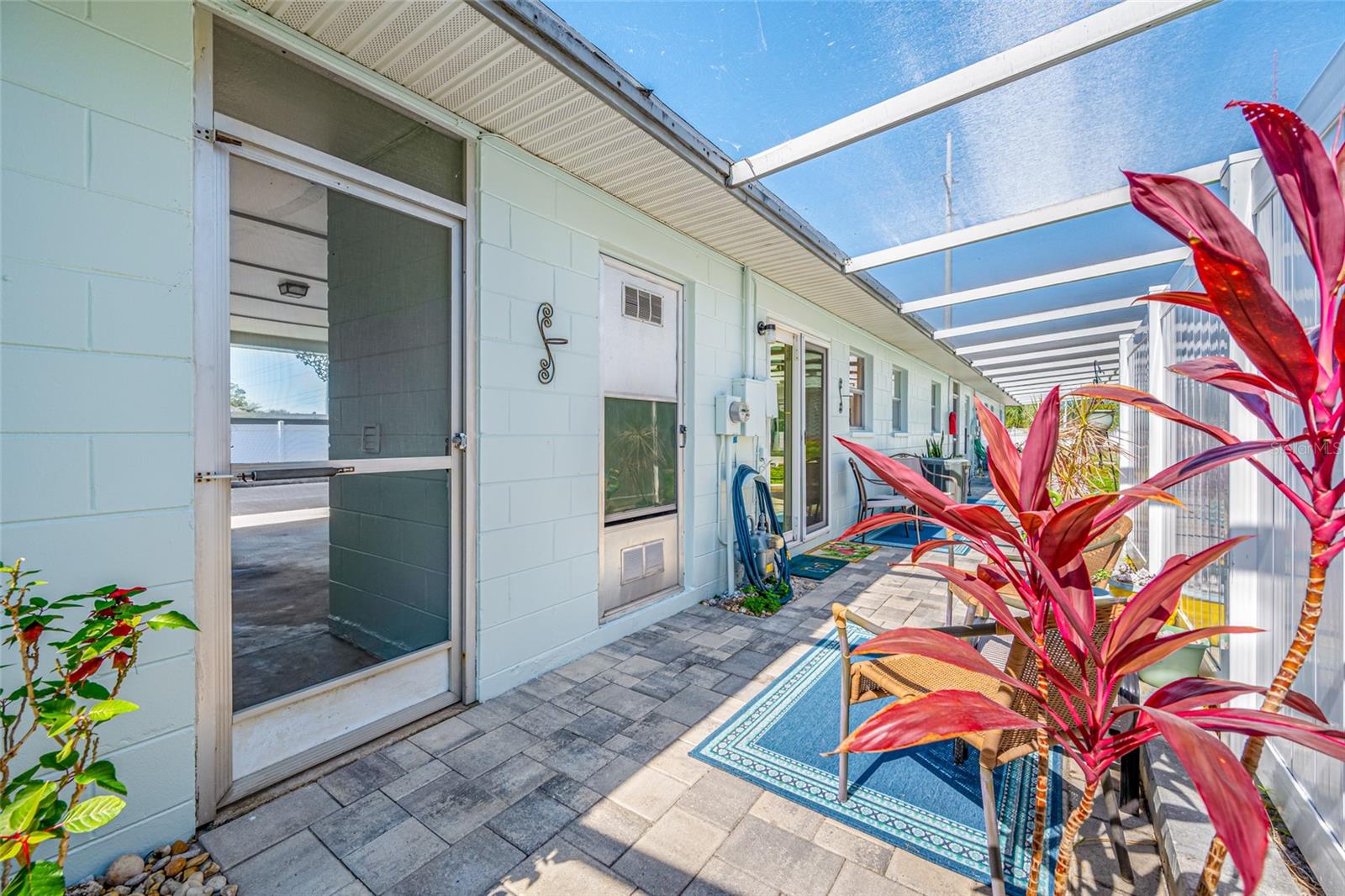 Fully screened lanai behind the home with pavers