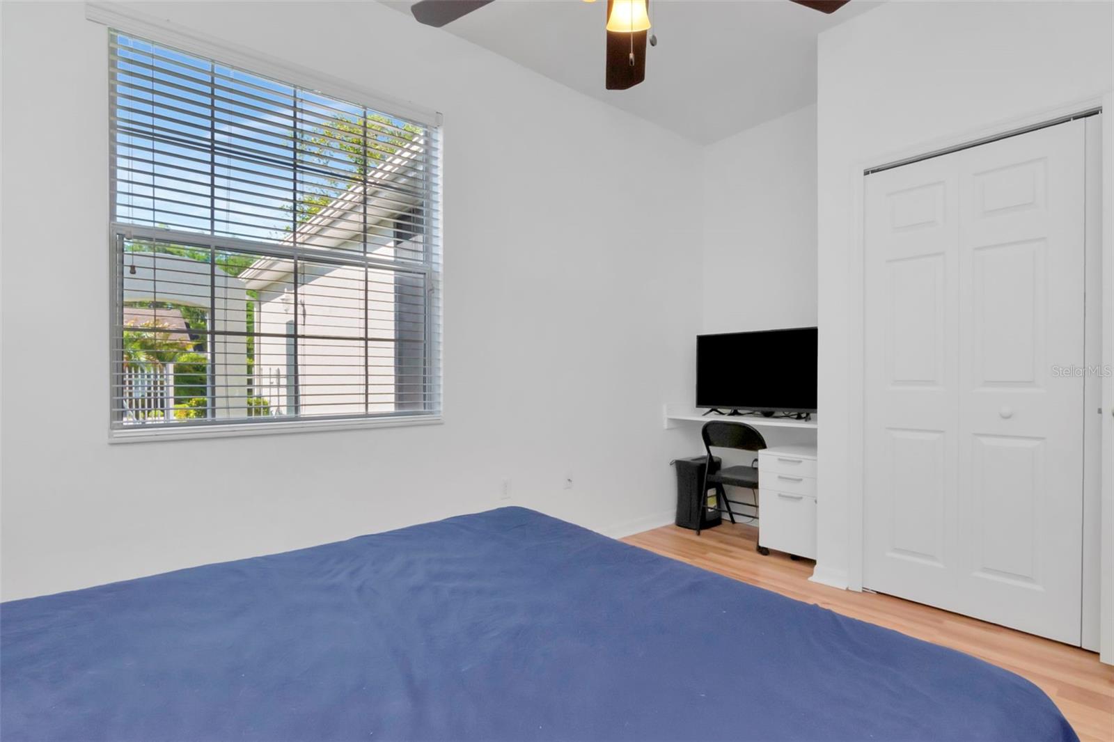 Spacious guest bedroom featuring a built-in desk and flexible layout