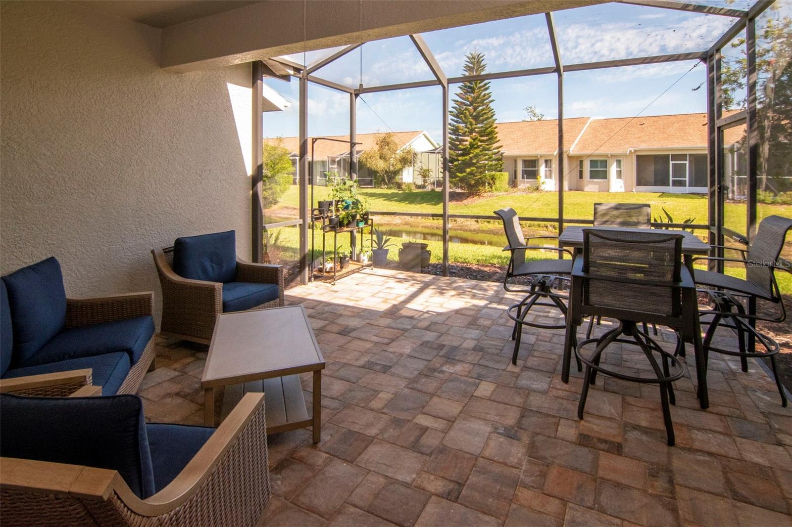 Upgraded paver patio with peaceful water views