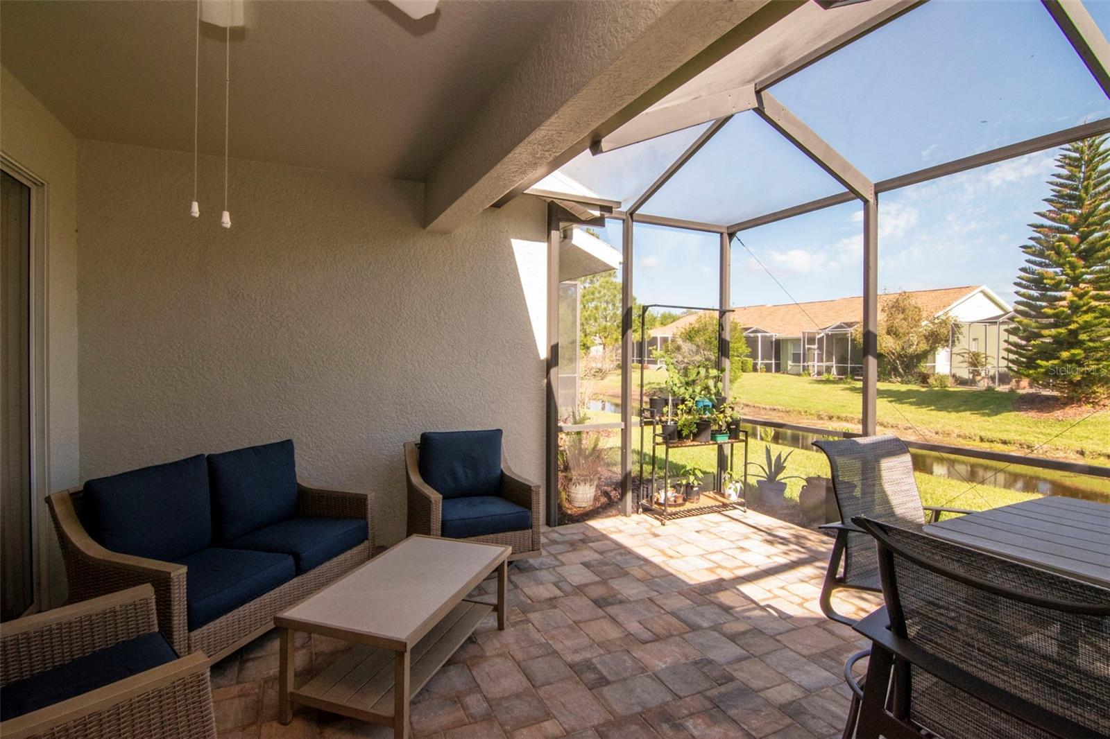 Beautiful pavered outdoor space overlooking the pond