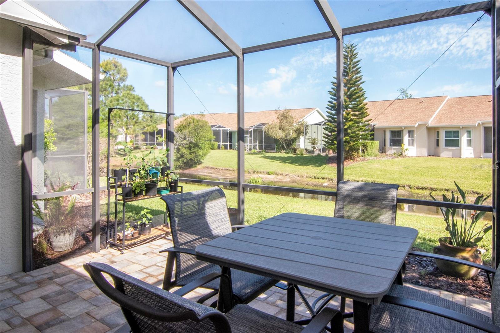 Custom paver lanai overlooking the pond—ideal for quiet mornings and relaxing evenings
