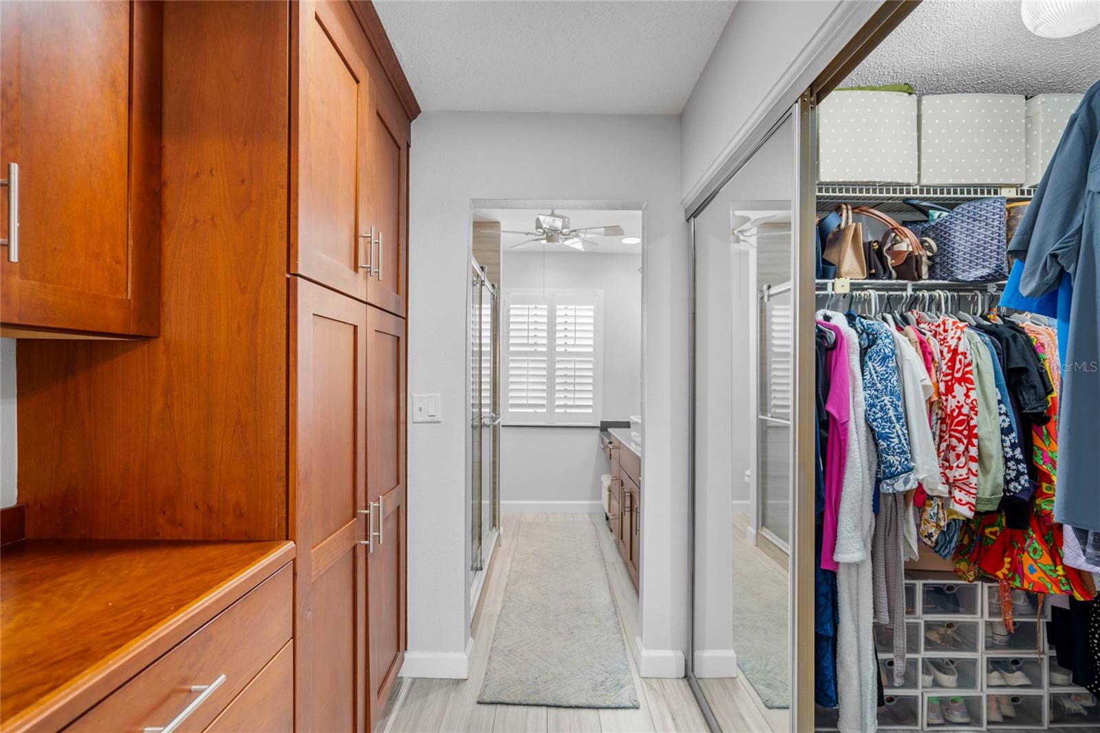 Primary Cabinetry and Closet Storage leads to Primary Bath