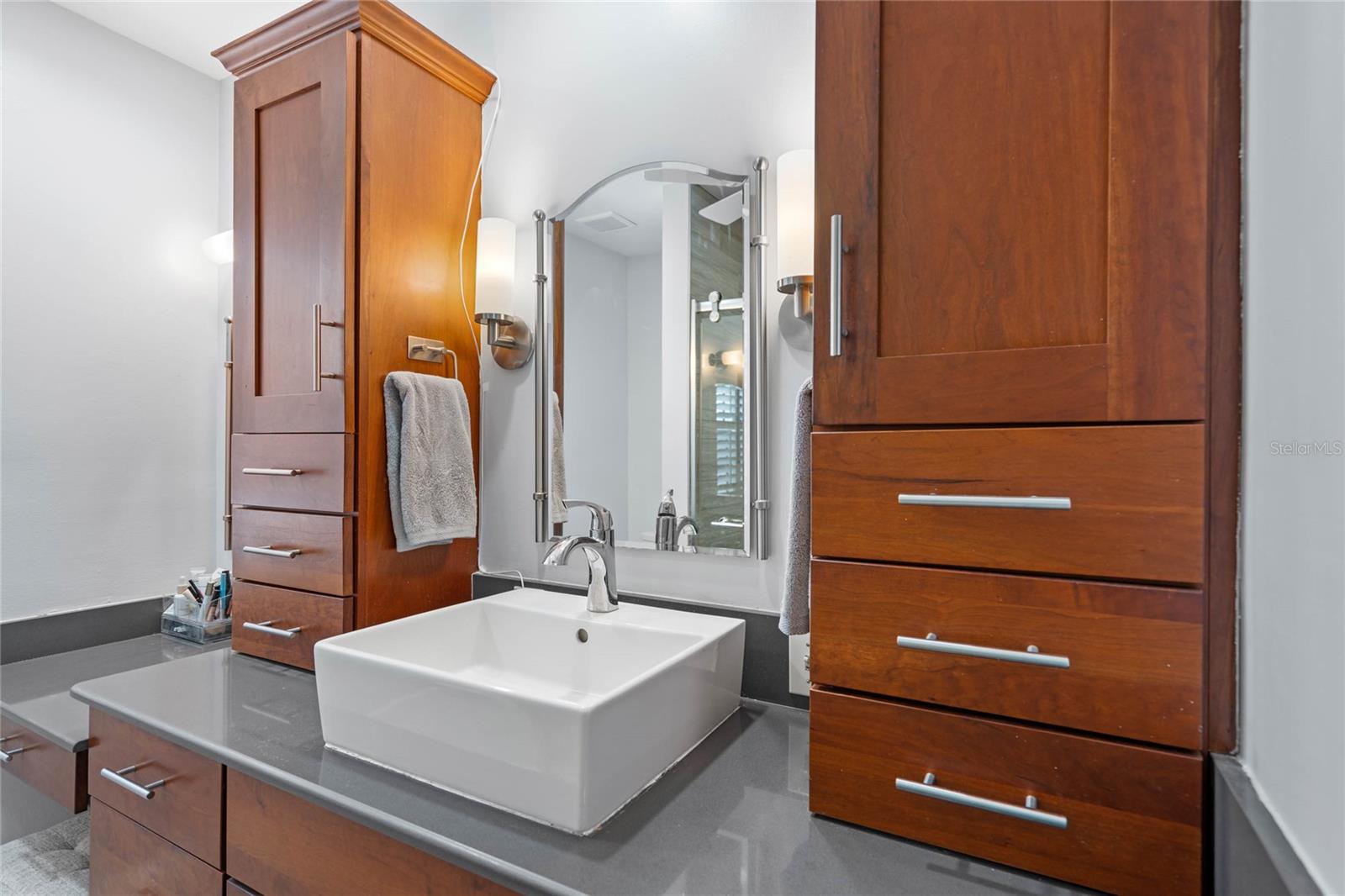 Single sink but very usable his/his/her/her storage cabinets