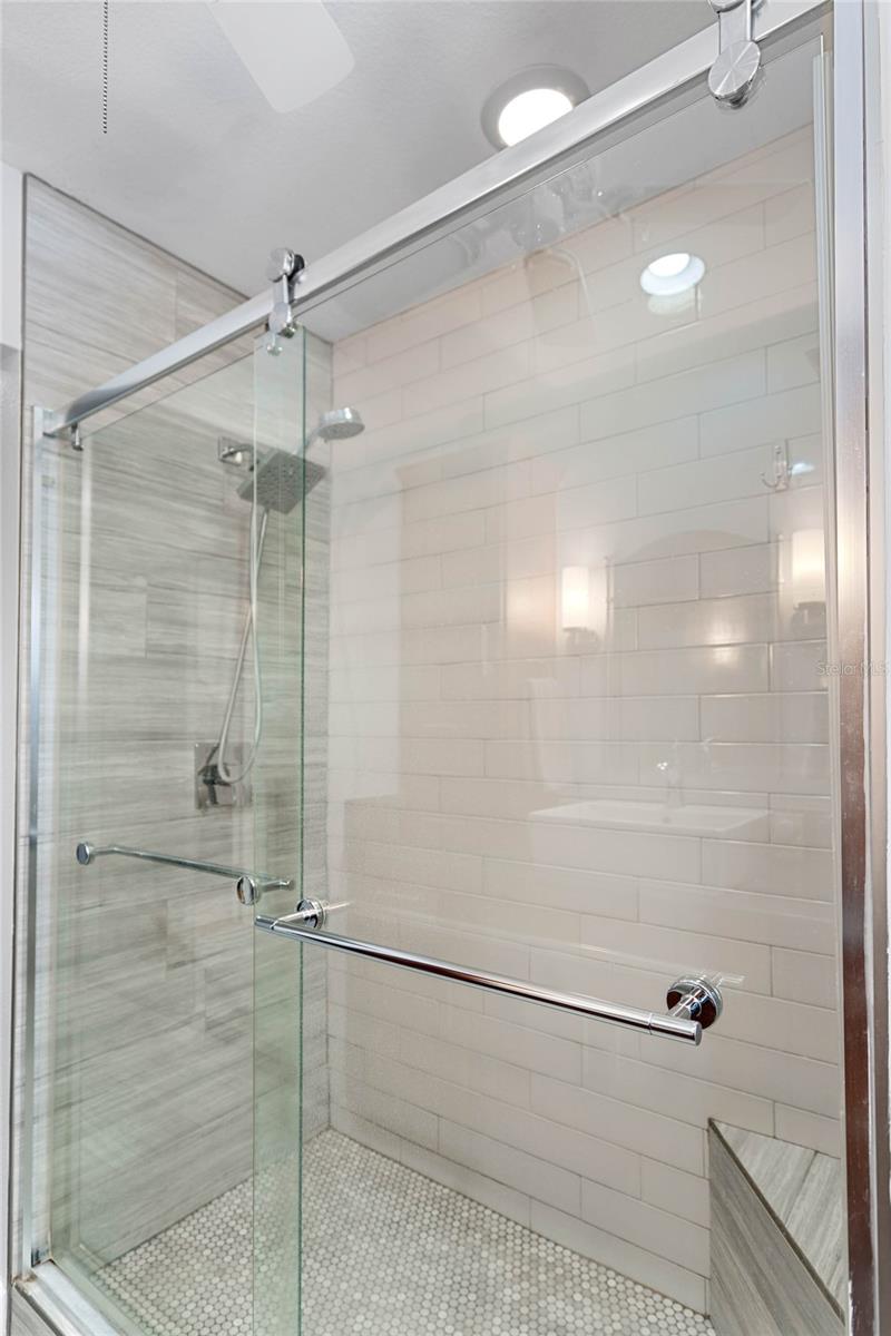 Nicely done step in shower and glass enclosure