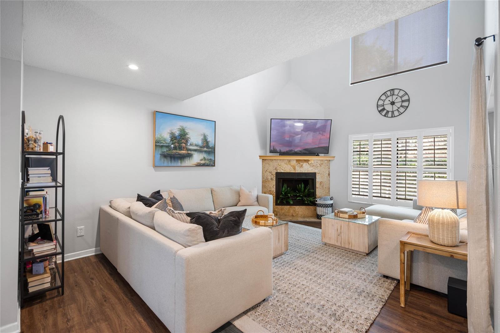 Cozy Living Space with Soaring Ceilings and lots of Natural Sunlight.  Wood Burning Fireplace for cool nights