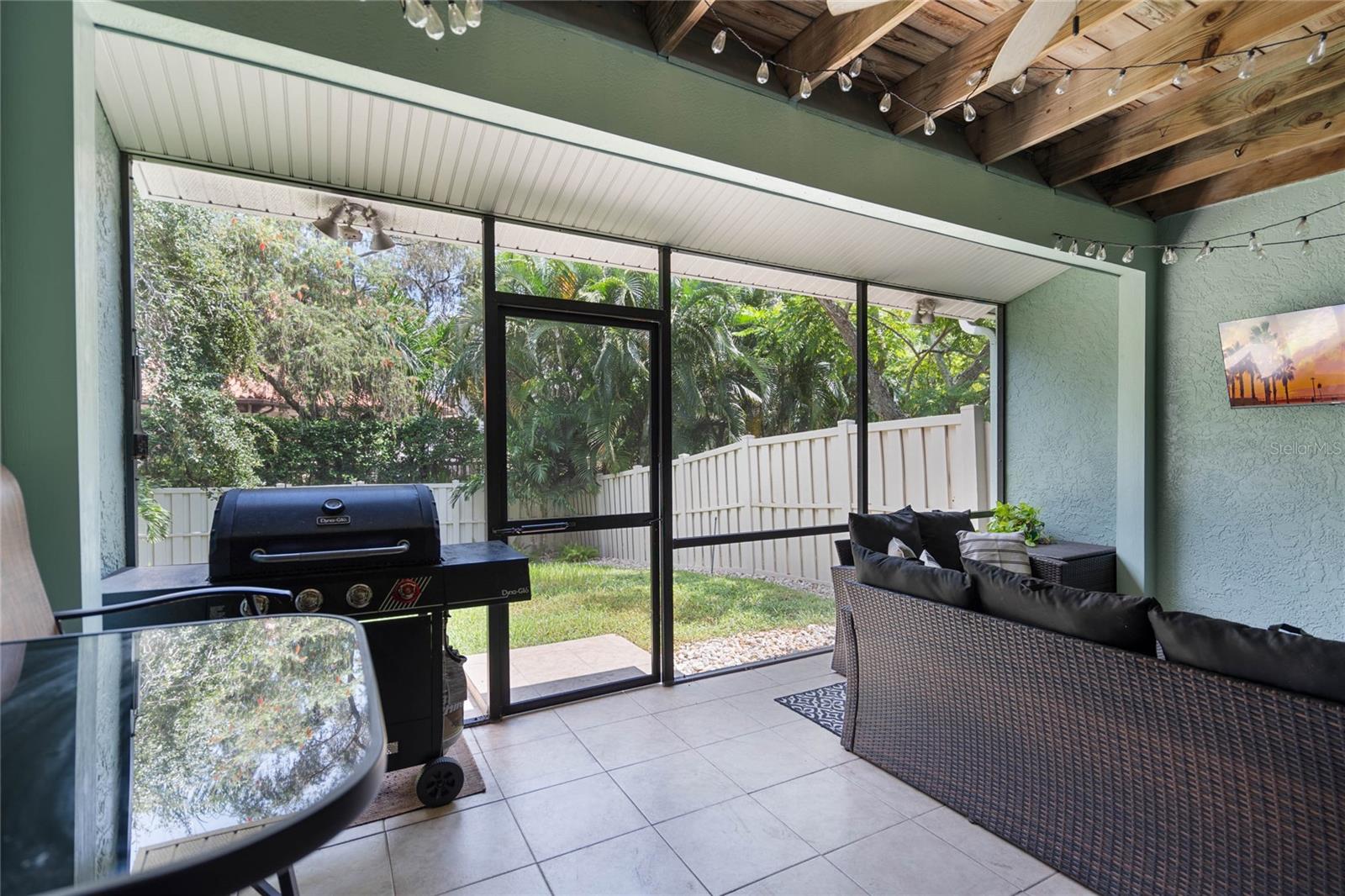 Downstairs Screened Porch living space and access to grassy backyard for kids and pets