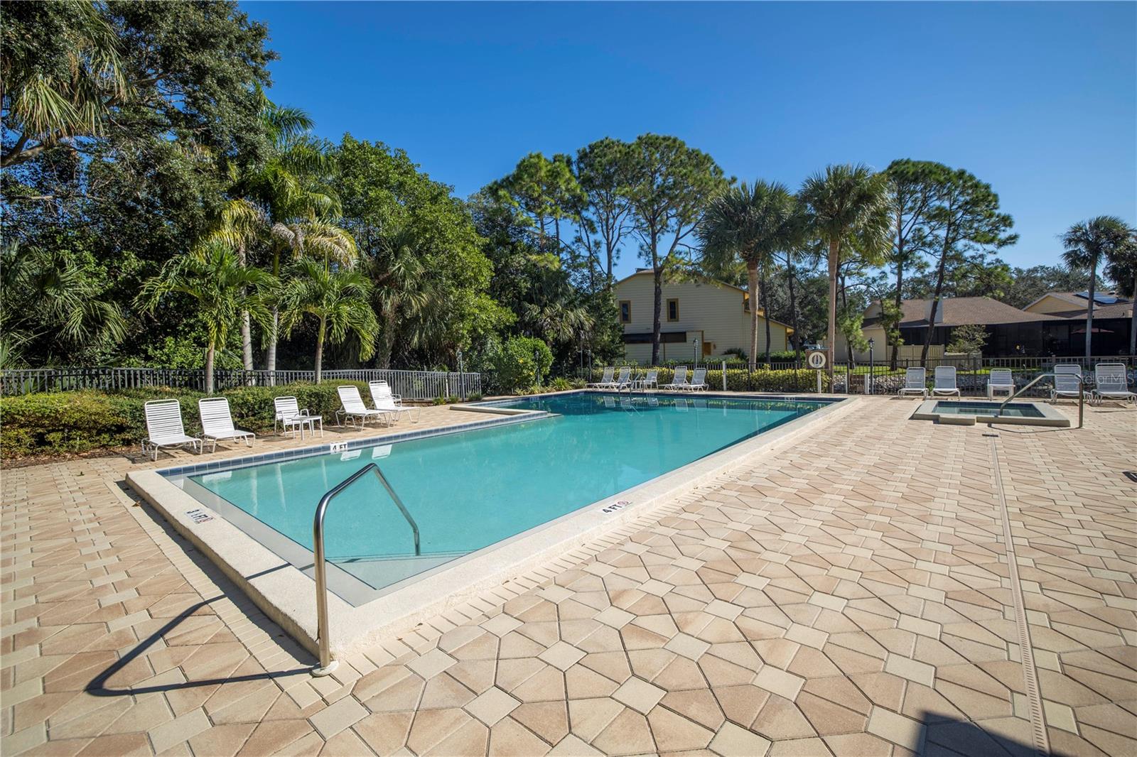 Resort Style Pool with plenty of pool deck and chaises