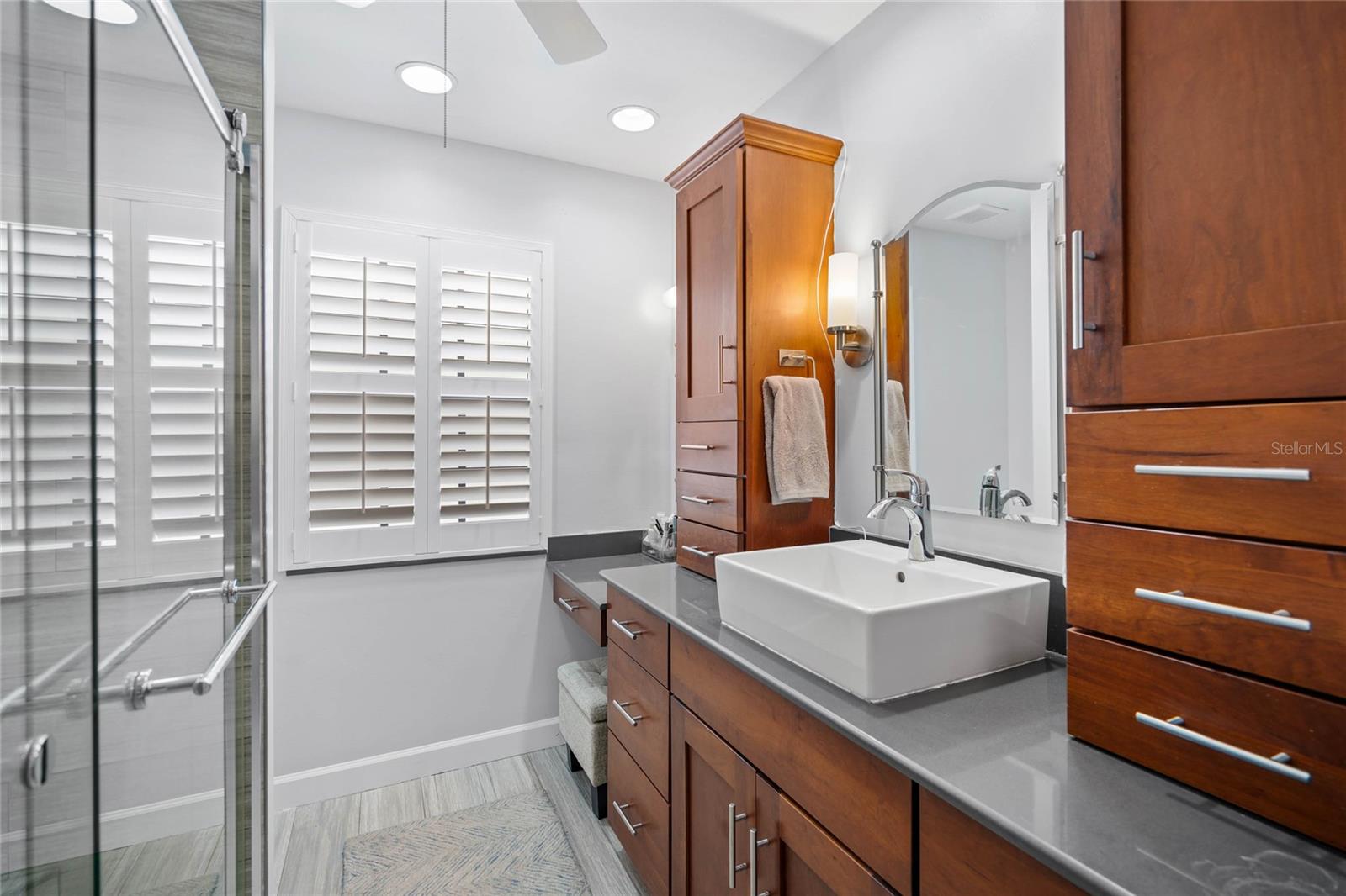 Modern Style Primary Bath with beautiful cabinetry and stone counters.  Step-in Shower