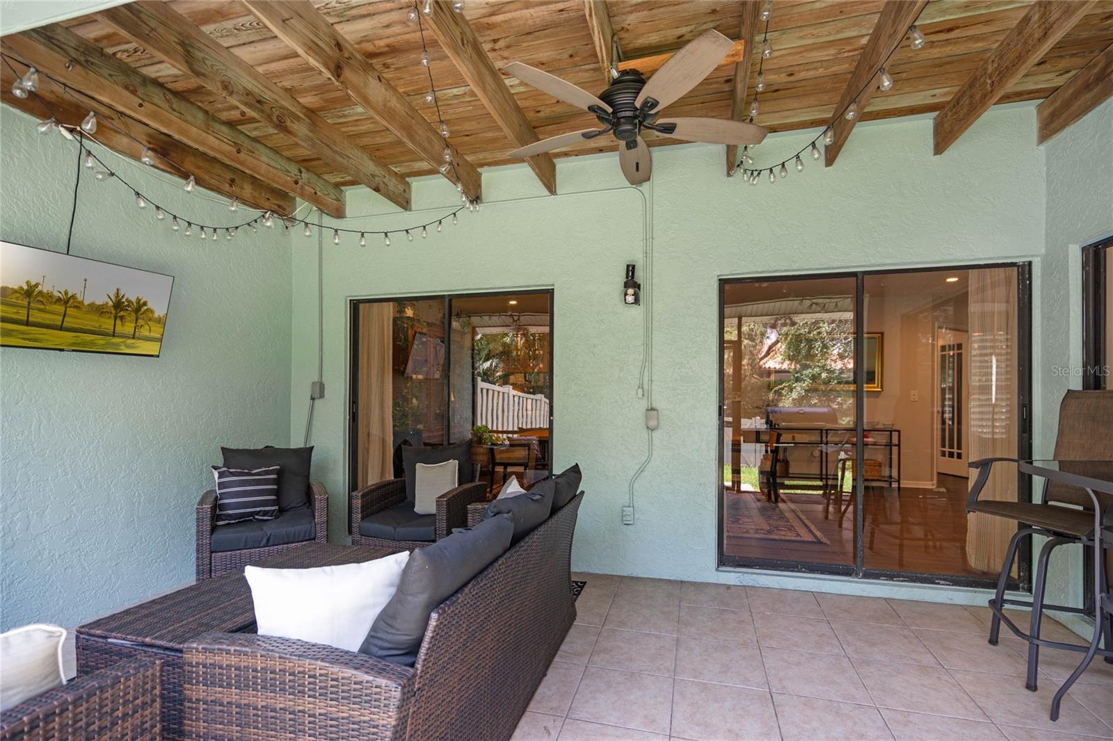 Covered and screened outdoor space with 3 sets of sliders to bring the outside in on those perfect days.