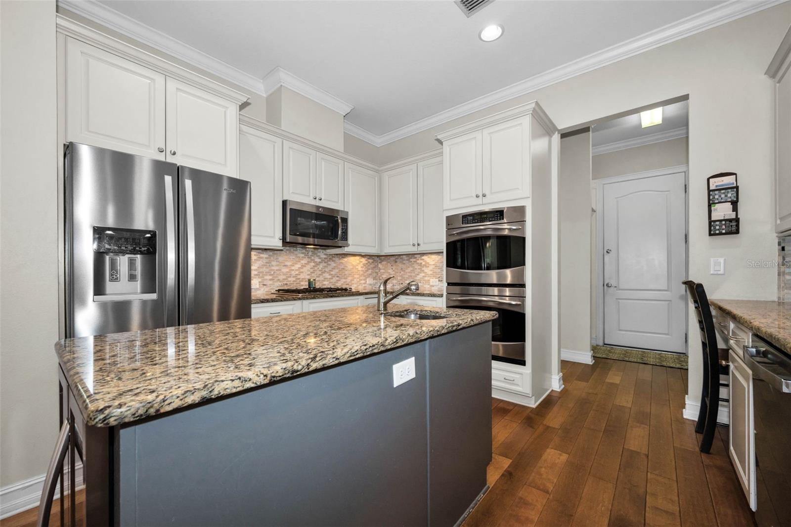 KITCHEN WITH HALLWAY TO PANTRY AND LAUNDRY ROOM