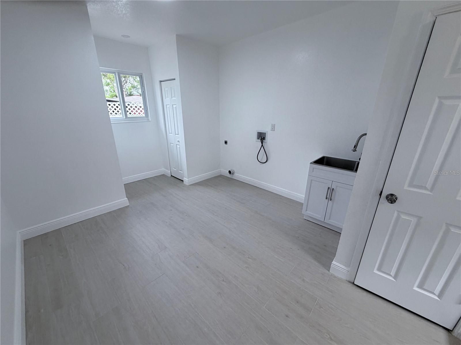 Huge laundry with half bath, laundry tub & extra storage.