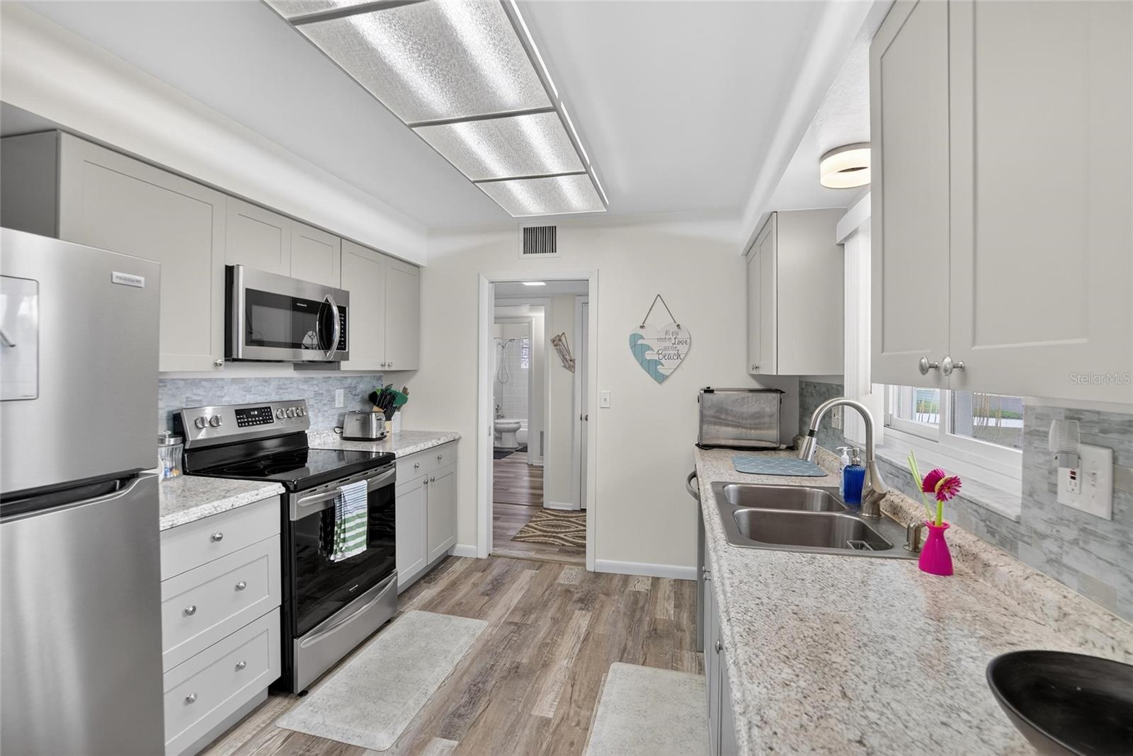 Modern, clean and bright this sparkling kitchen has lots of storage and all the features a cook could want