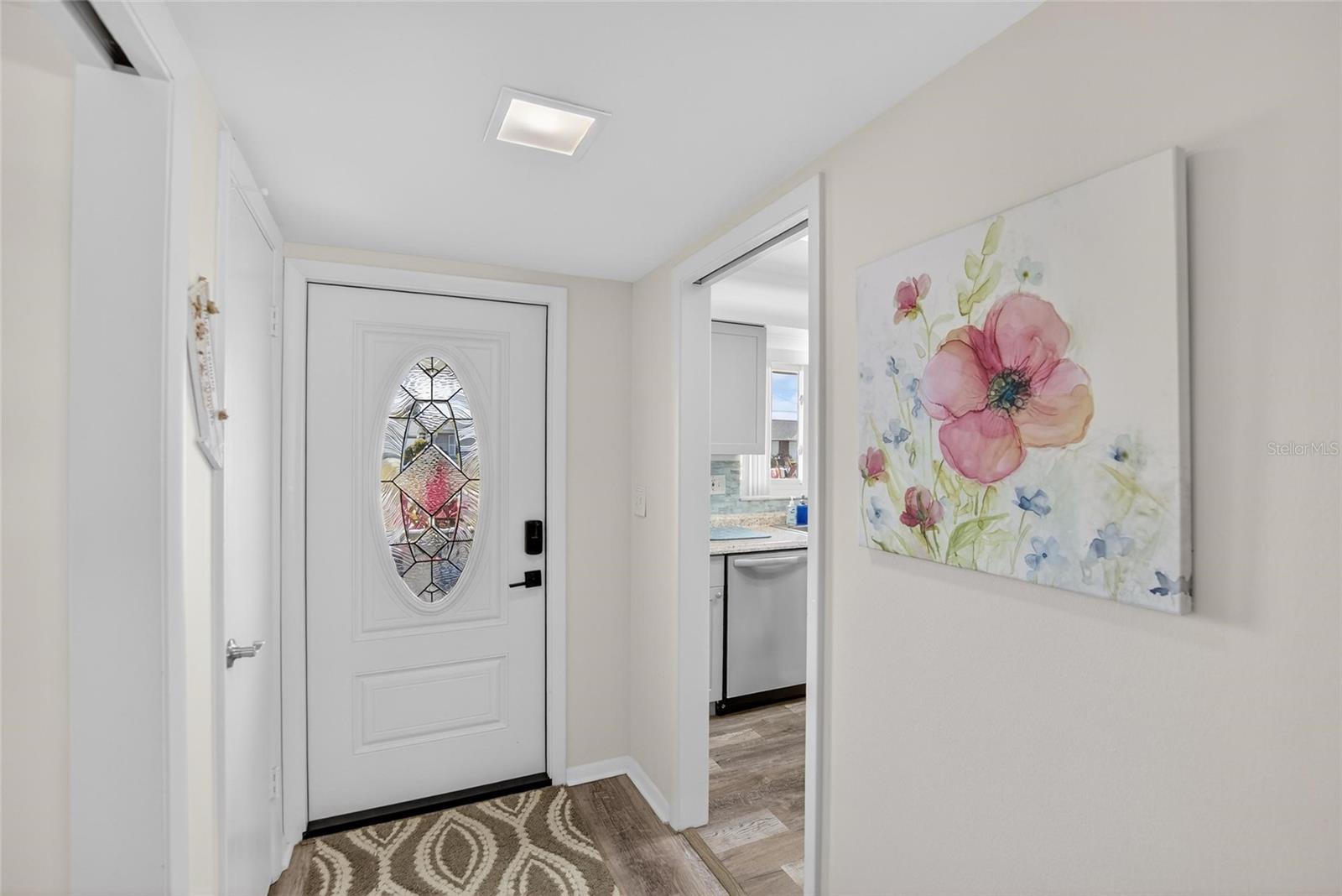 Walking in the lead glass door with keyless entry, notice the beautiful continuous floor