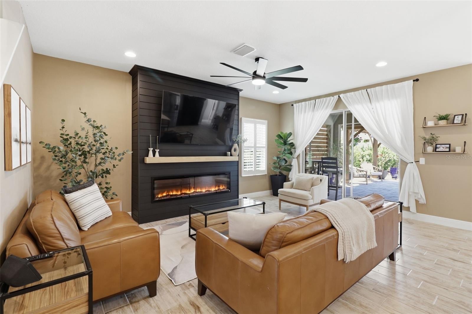 Cozy living room featuring a stylish accent wall, electric fireplace, and space for your TV.