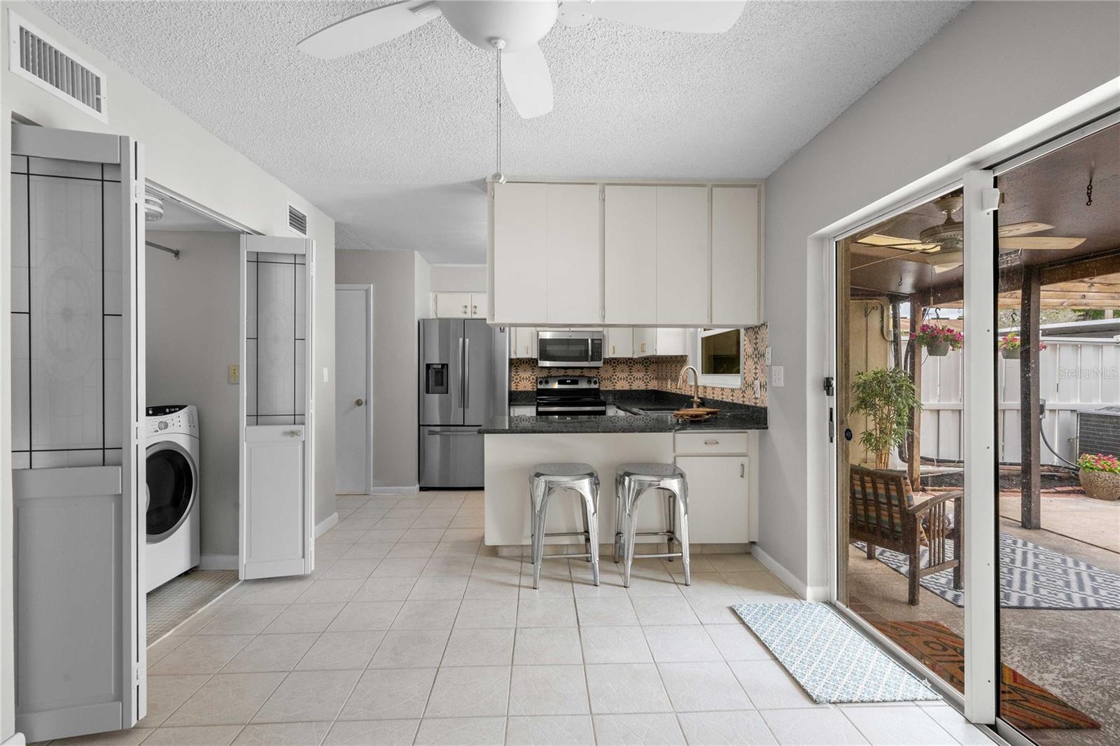 Dining room looking into kitchen and patio