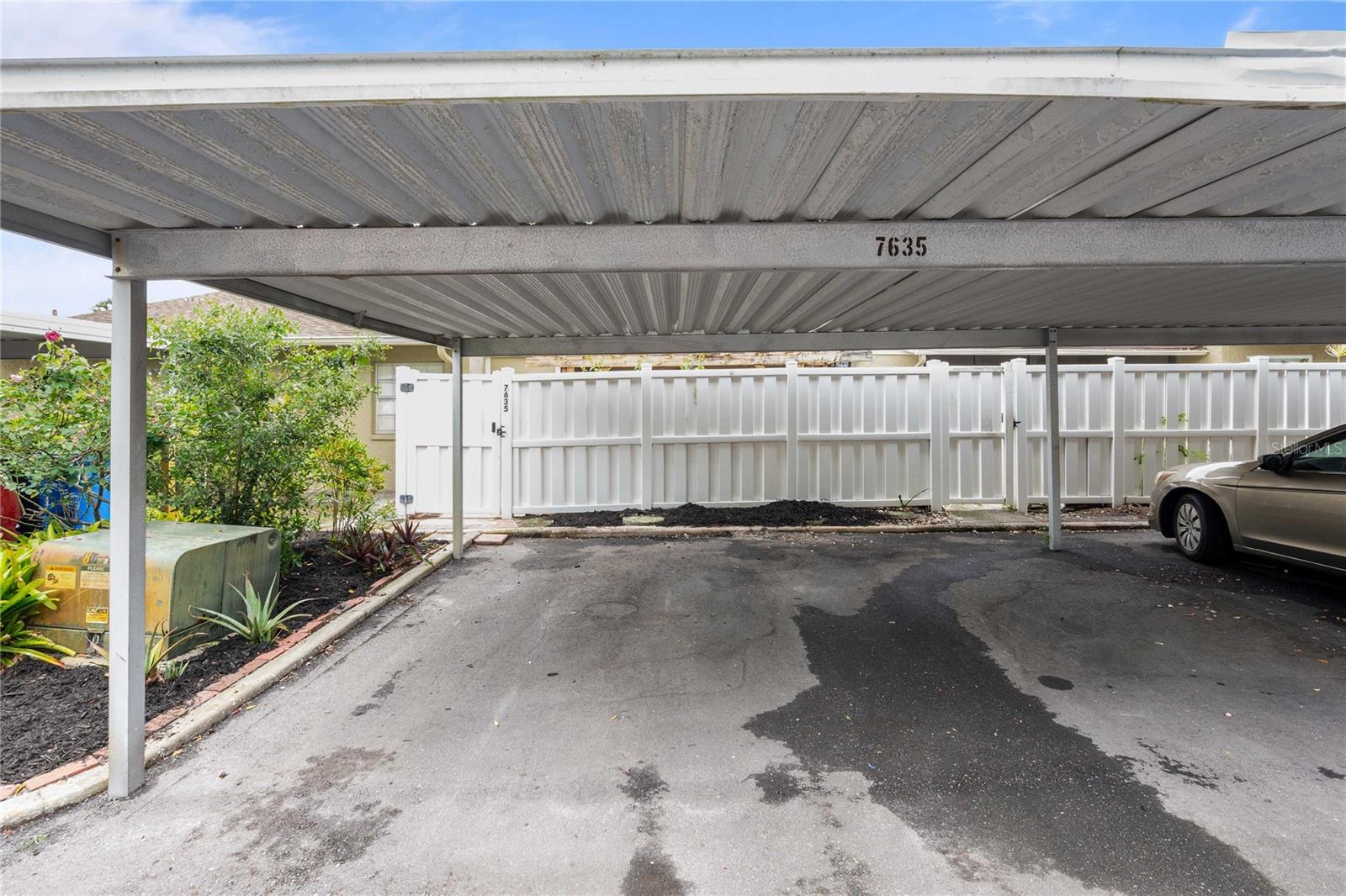 covered carport, with private entrance to patio to the back of house.