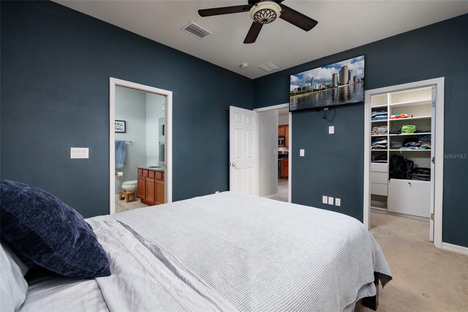 Primary Bedroom - view to entrance, walk in closet, and en suite bath.