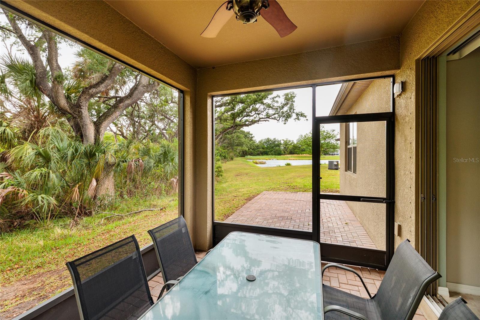 Screened Porch - view to the patio with pavers.