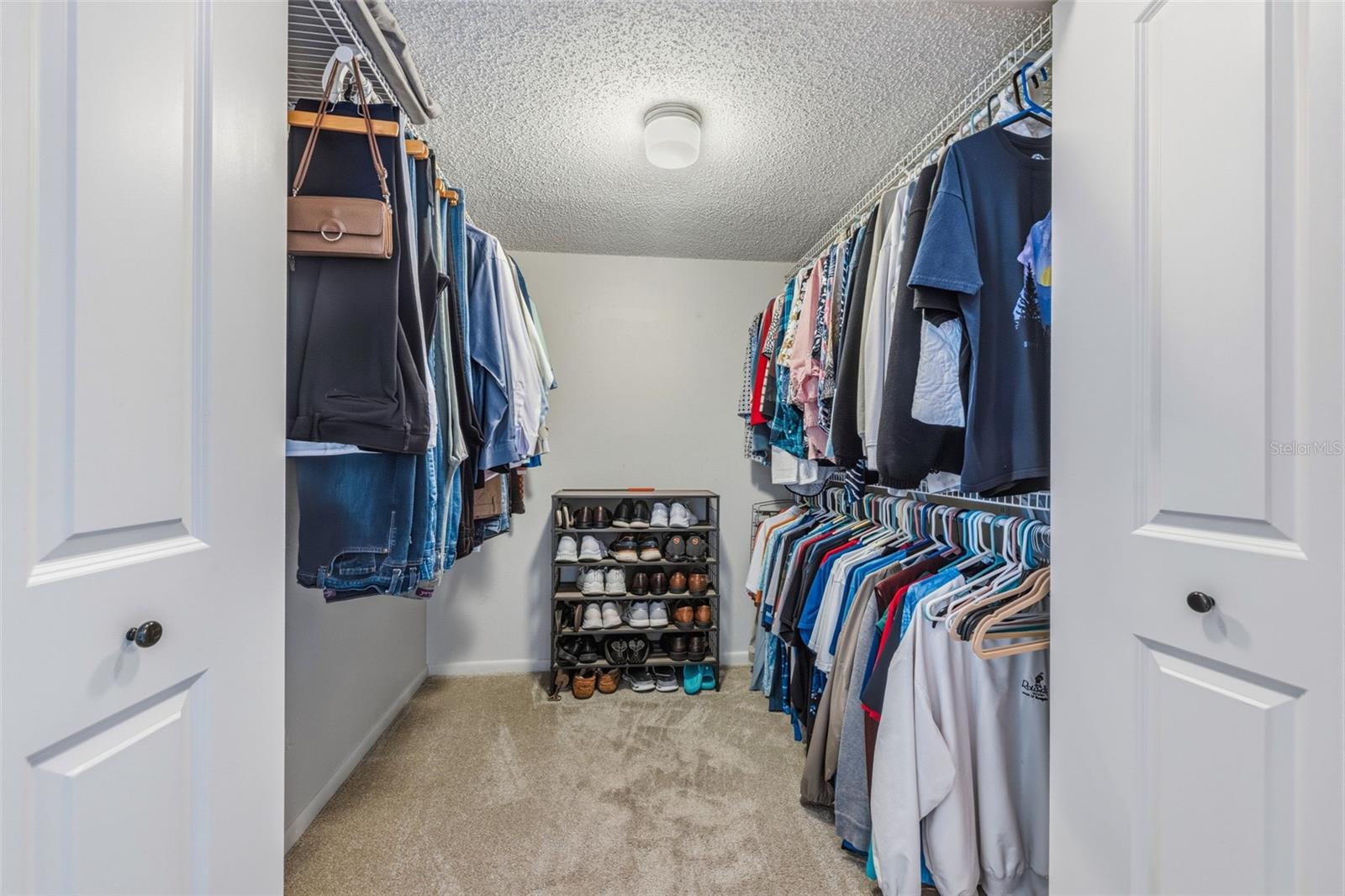 Primary bedroom walk in closet