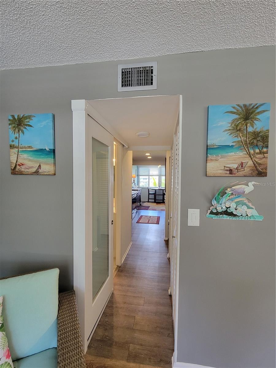 Hallway from livind/dining area to rear of unit overlooking courtyard