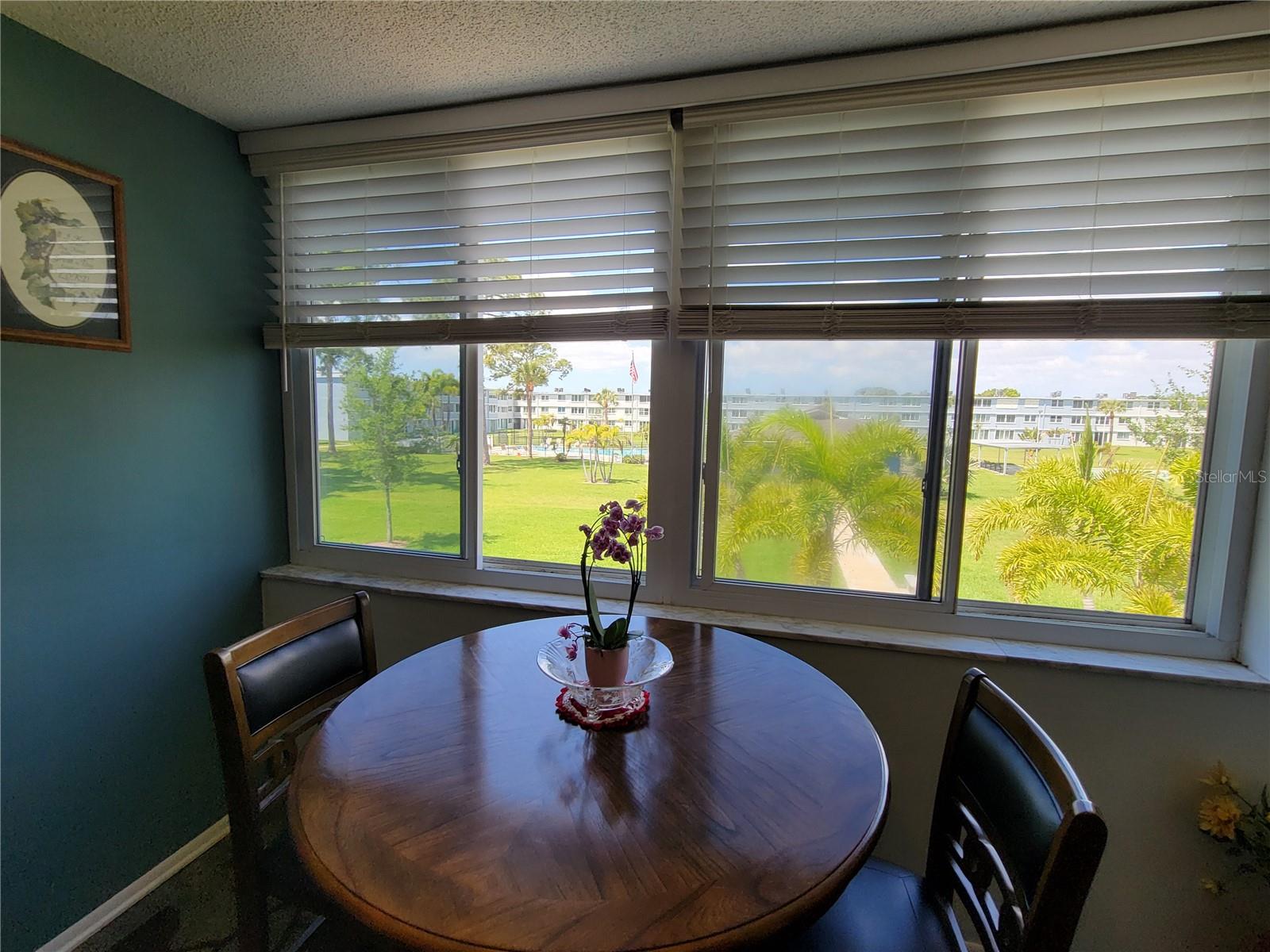 Courtyard-View Dinette: A bright and airy space that brings the serene courtyard scenery inside.