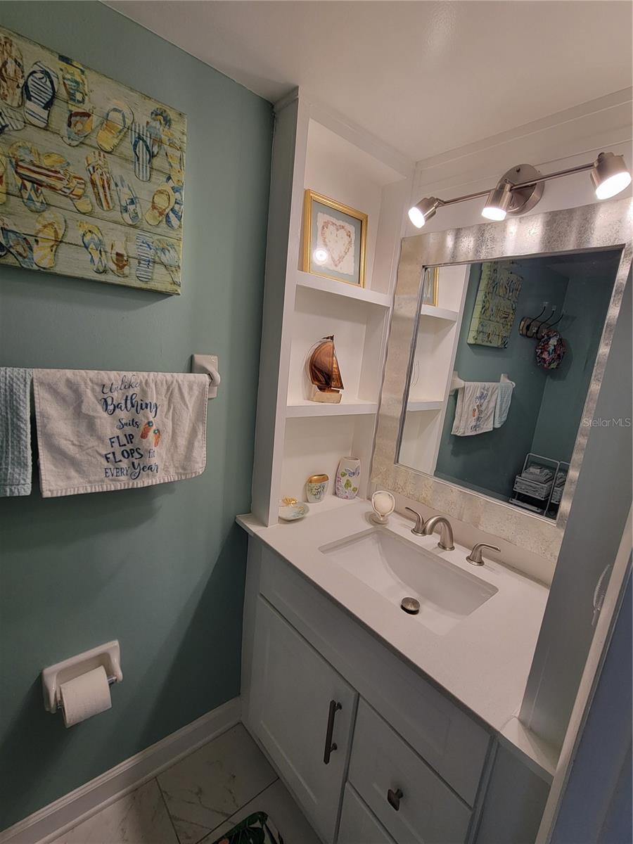 A half bath that offers abundant storage and lighting