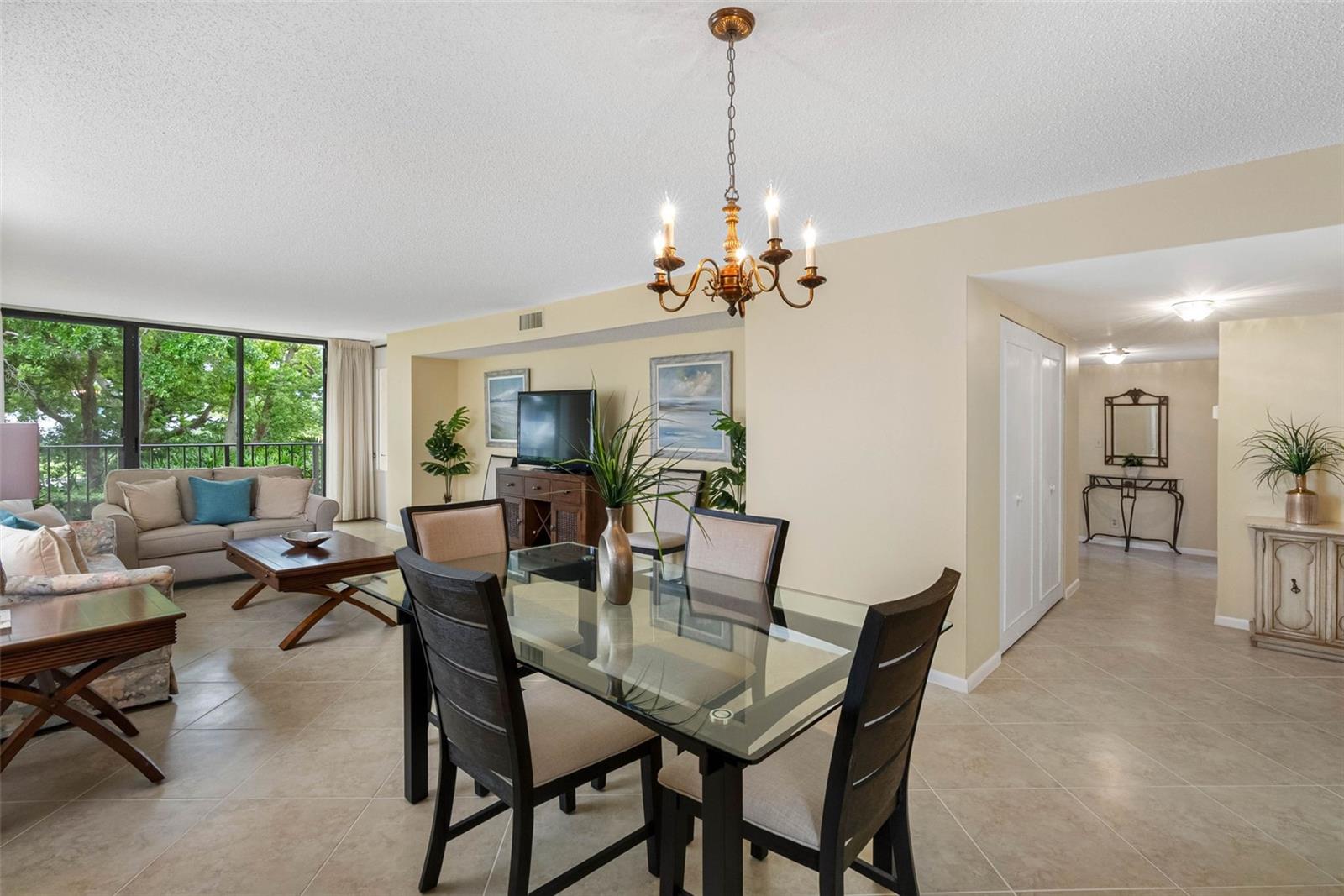 Open Foyer to Dining and Living/Green views off of balcony