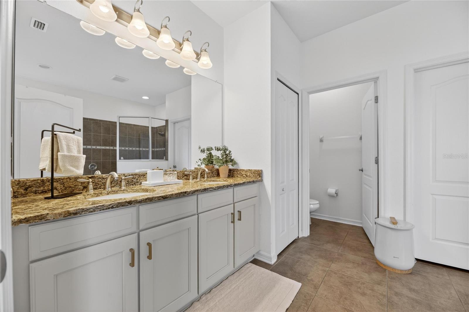 Ensuite bath has a walk-in closet, and separate toilet room.