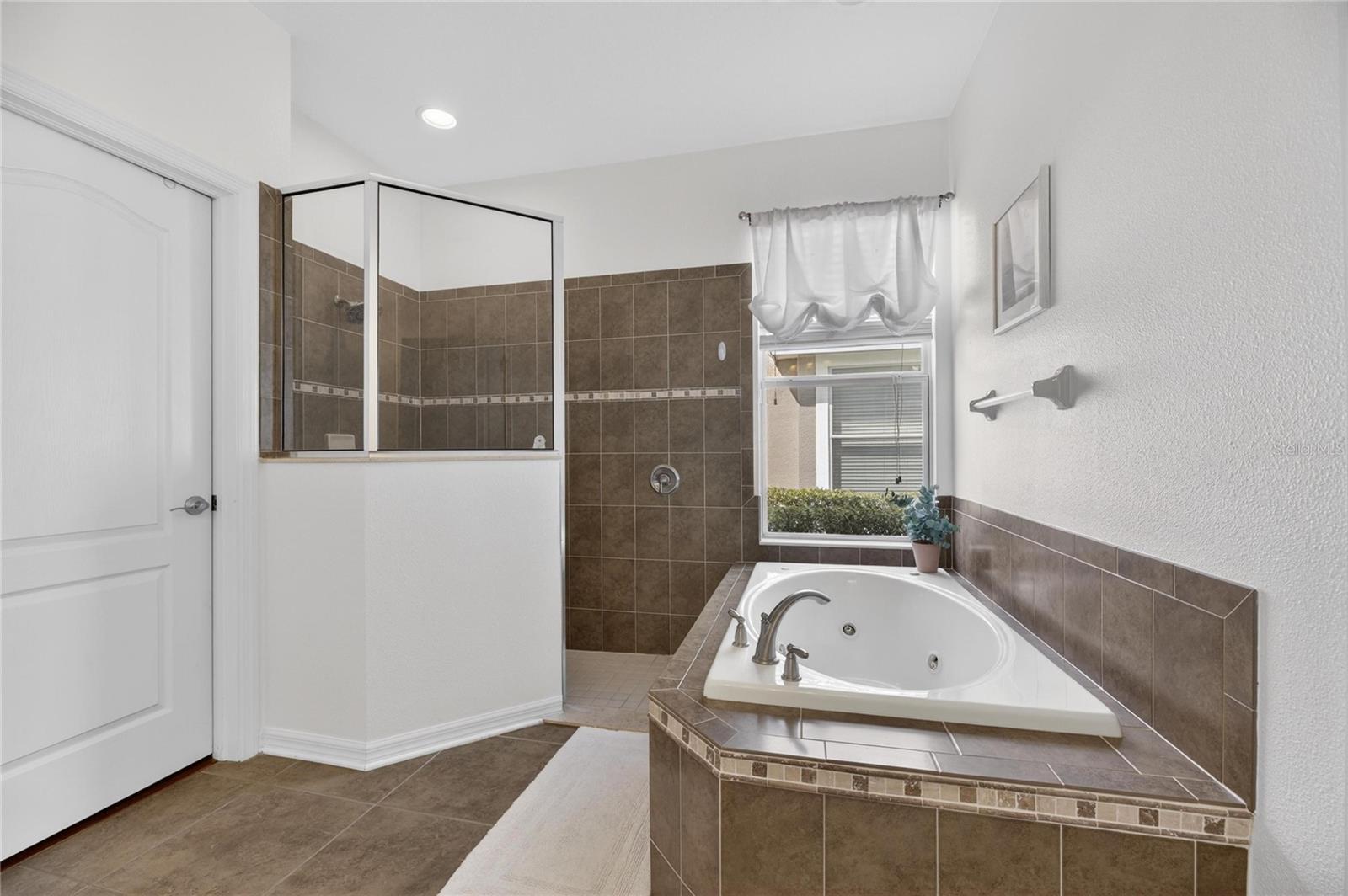 Primary bath has a big soaking tub and separate  shower.