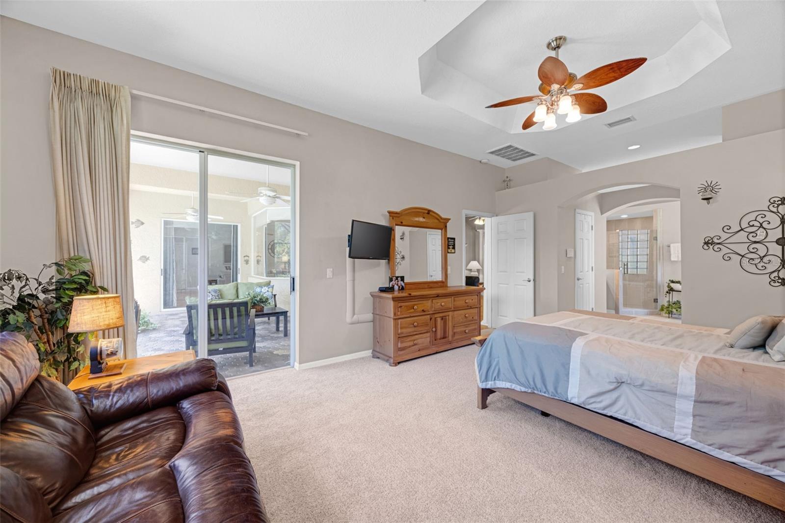 The very spacious Primary Bedroom features a glass slider to the pool and jacuzzi, a tray ceiling, and brand new carpet in April 2026.