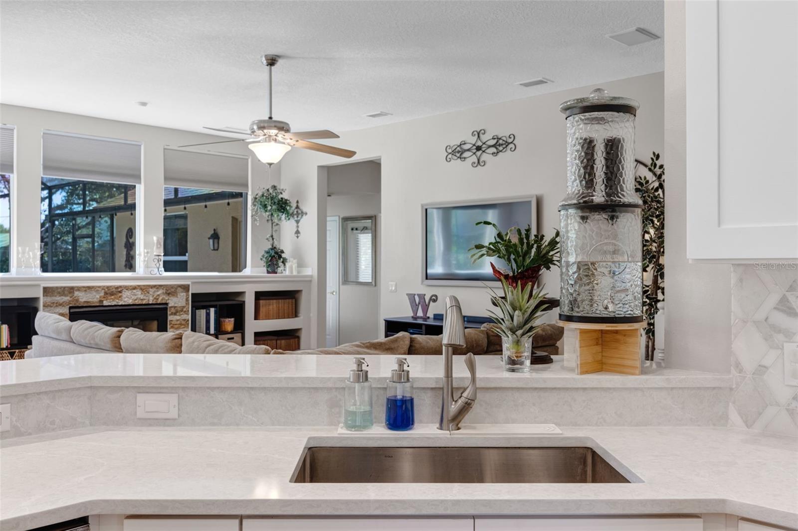 Wash dishes while watching everything going on in the Great Room.