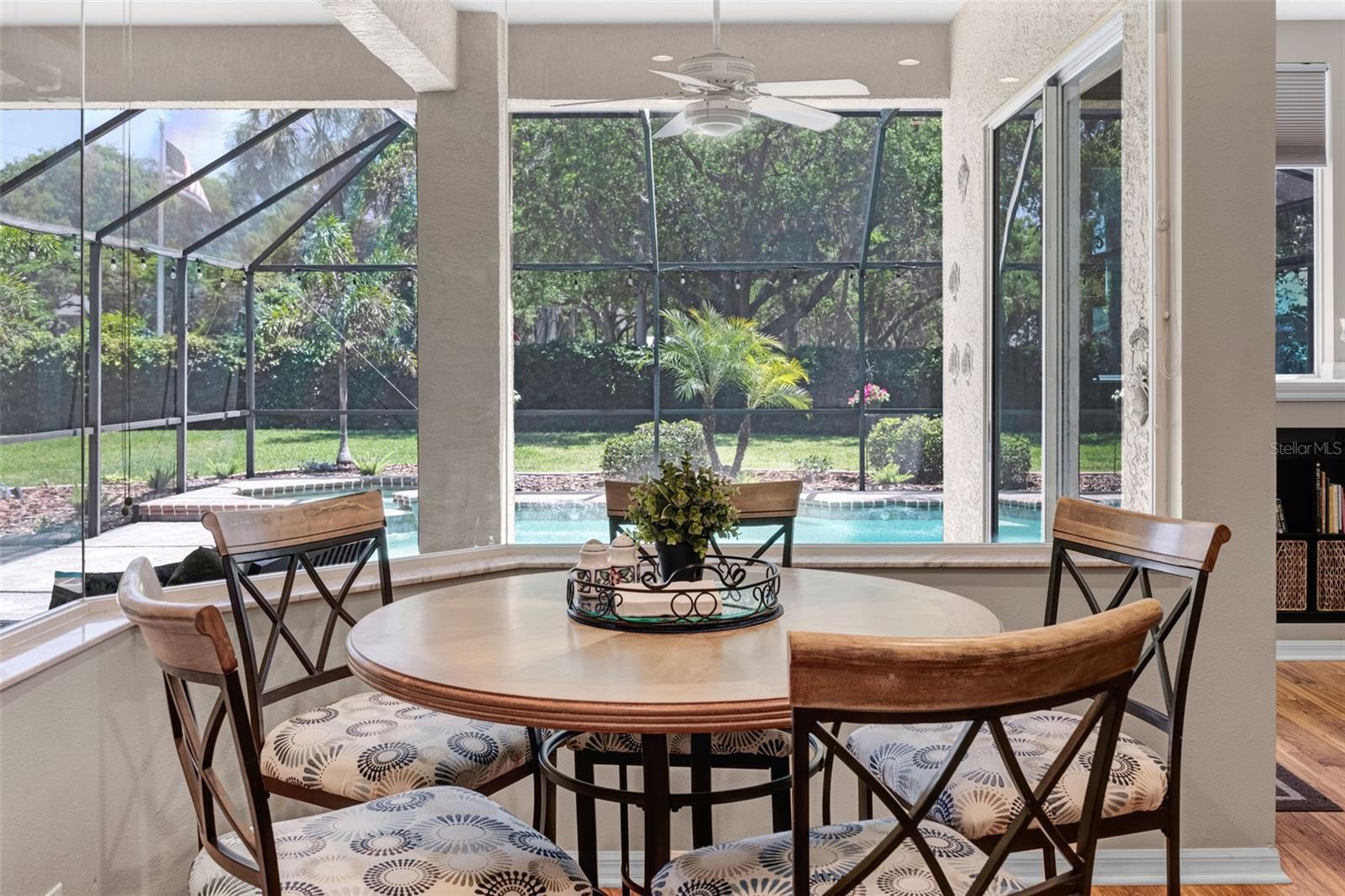 The eat-in area looks out to the pool and jacuzzi through a beautiful frameless window.