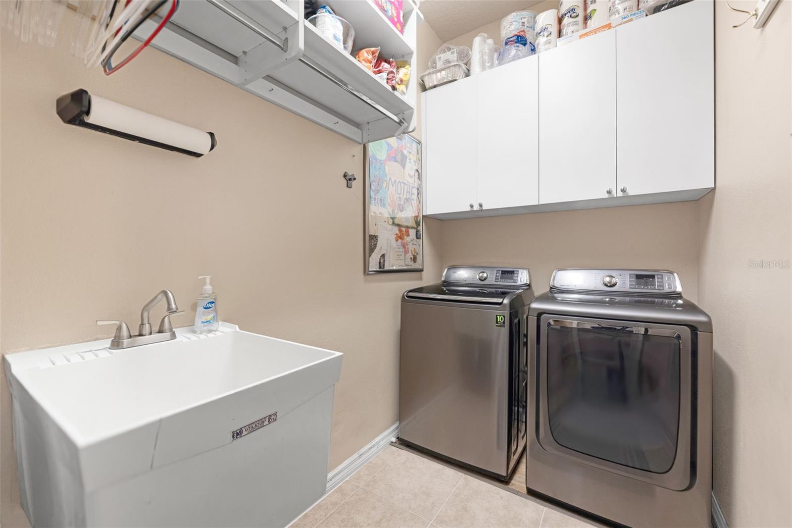 The Laundry Room has a sink, overhead cabinets, and lots of storage space.
