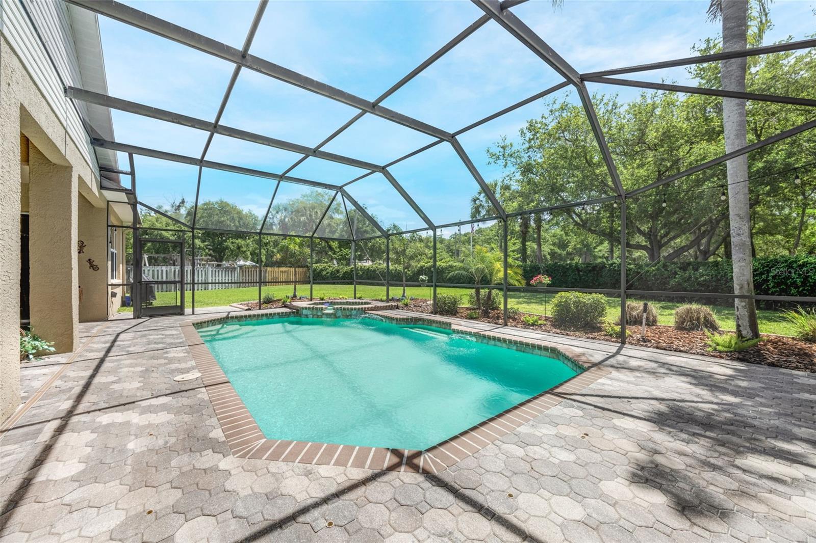 A gorgeous and very private backdrop beyond the screened-in area.