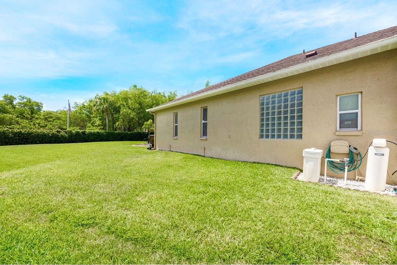 The extremely spacious backyard!  Here you can see the water softener equipment.