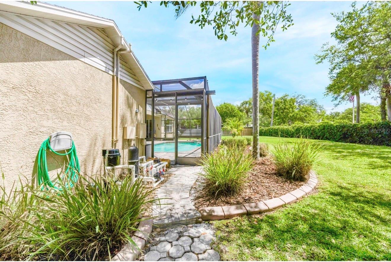 There's a pavered walkway along the pool equipment.