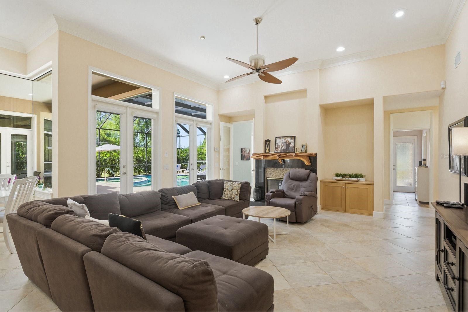 Open concept family room, pool & lanai views · 976 Cypress Cove Way Tarpon Springs FL 34688