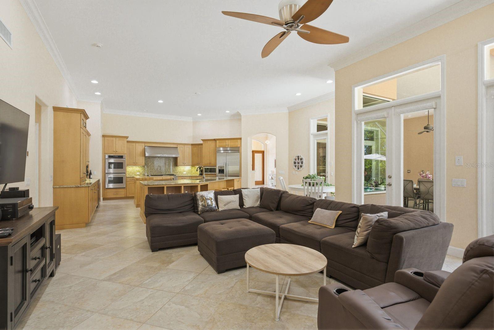 Family room and Kitchen with soaring ceilings & open concept living · 976 Cypress Cove Way Tarpon Springs FL 34688