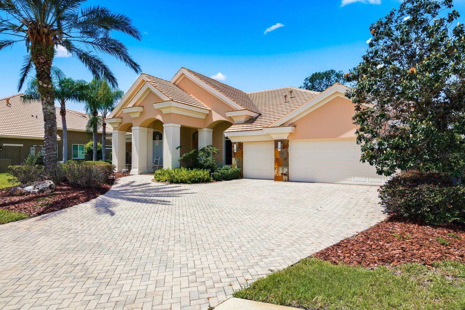 Grand brick-paved driveway, lush landscaping · 976 Cypress Cove Way Tarpon Springs FL 34688
